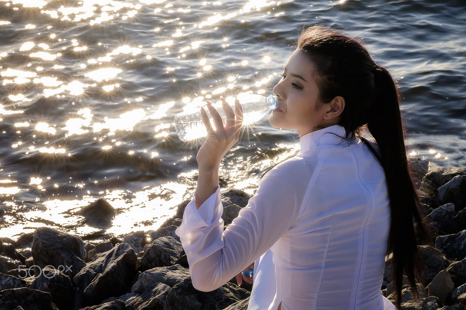 Fujifilm X-E2 sample photo. Beautiful woman in vietnam dress drinking water on sunset evening in lake. photography