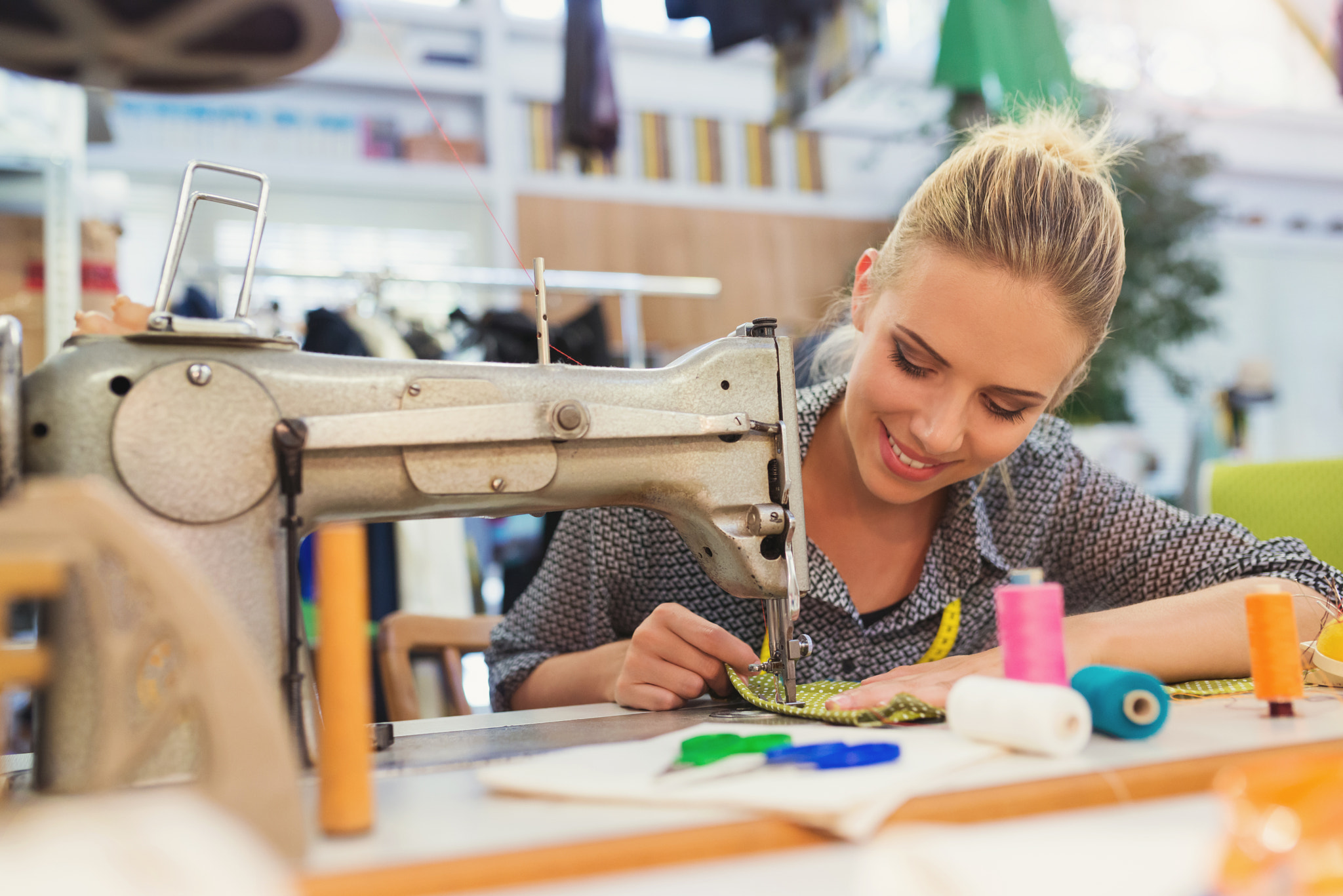 Young woman with sewing machine