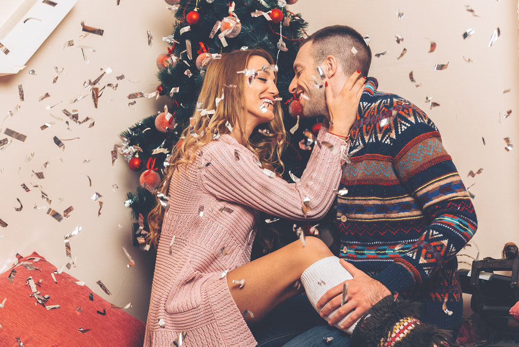 Young couple under christmas tree by Igor  Milic on 500px.com