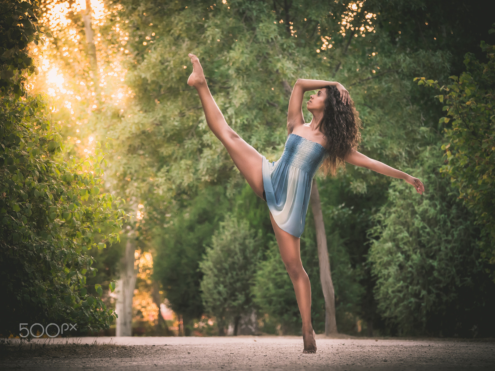 Panasonic Lumix DMC-GH3 sample photo. Latin dancer with leg raised in road full of vegetation photography