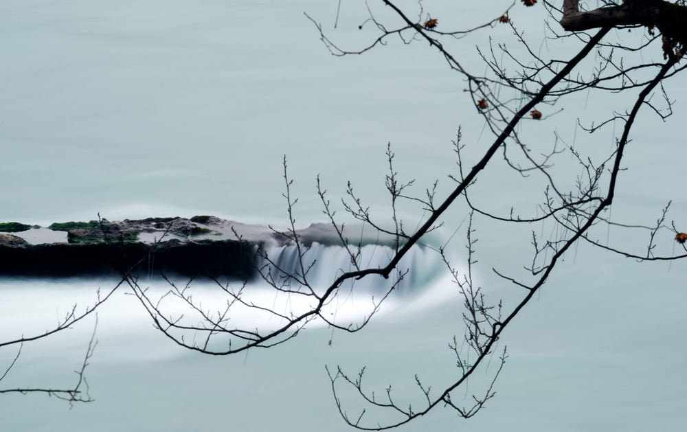 Nikon D80 + AF Zoom-Nikkor 70-210mm f/4 sample photo. Silky flowing river over rock photography
