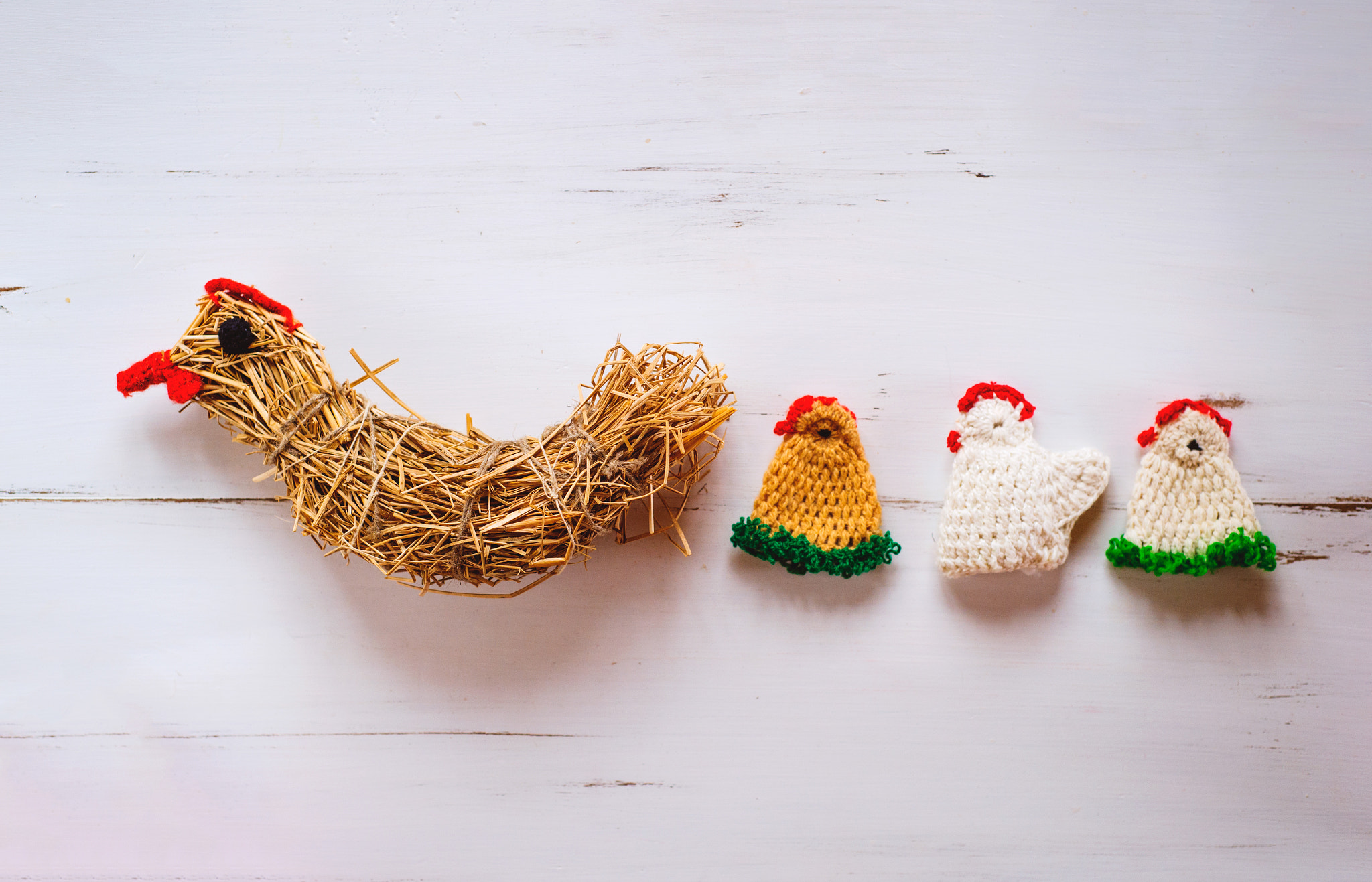 Nikon D4S sample photo. Three crocheted easter chickens and straw hen,white wooden backg photography