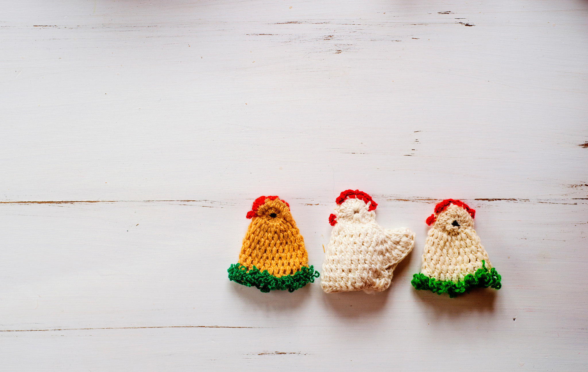 Nikon D4S + Nikon AF Nikkor 50mm F1.8D sample photo. Three colorful crocheted easter chickens against white wooden ba photography