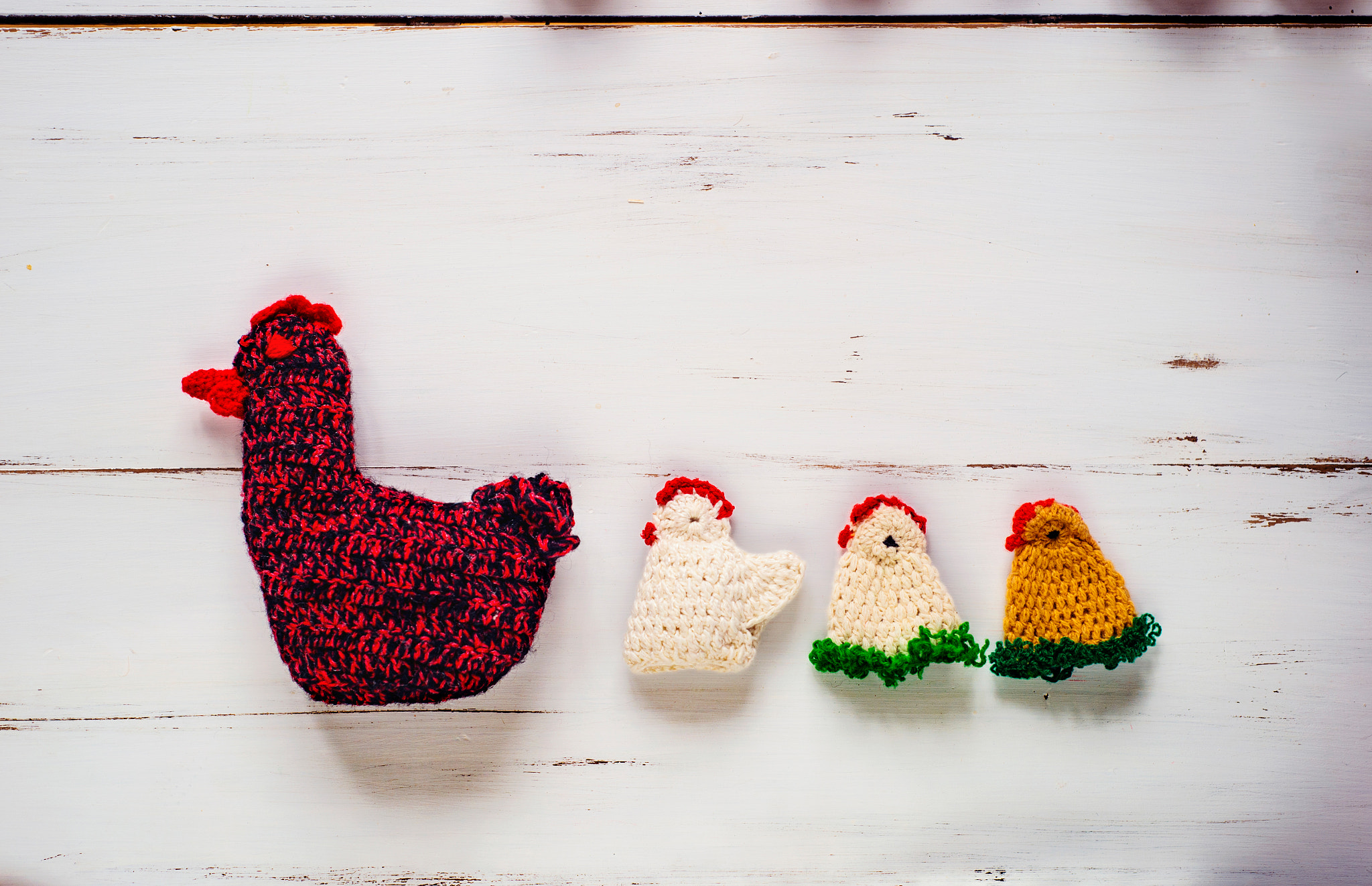 Nikon D4S sample photo. Three crocheted easter chickens and knitted hen,white wooden bac photography