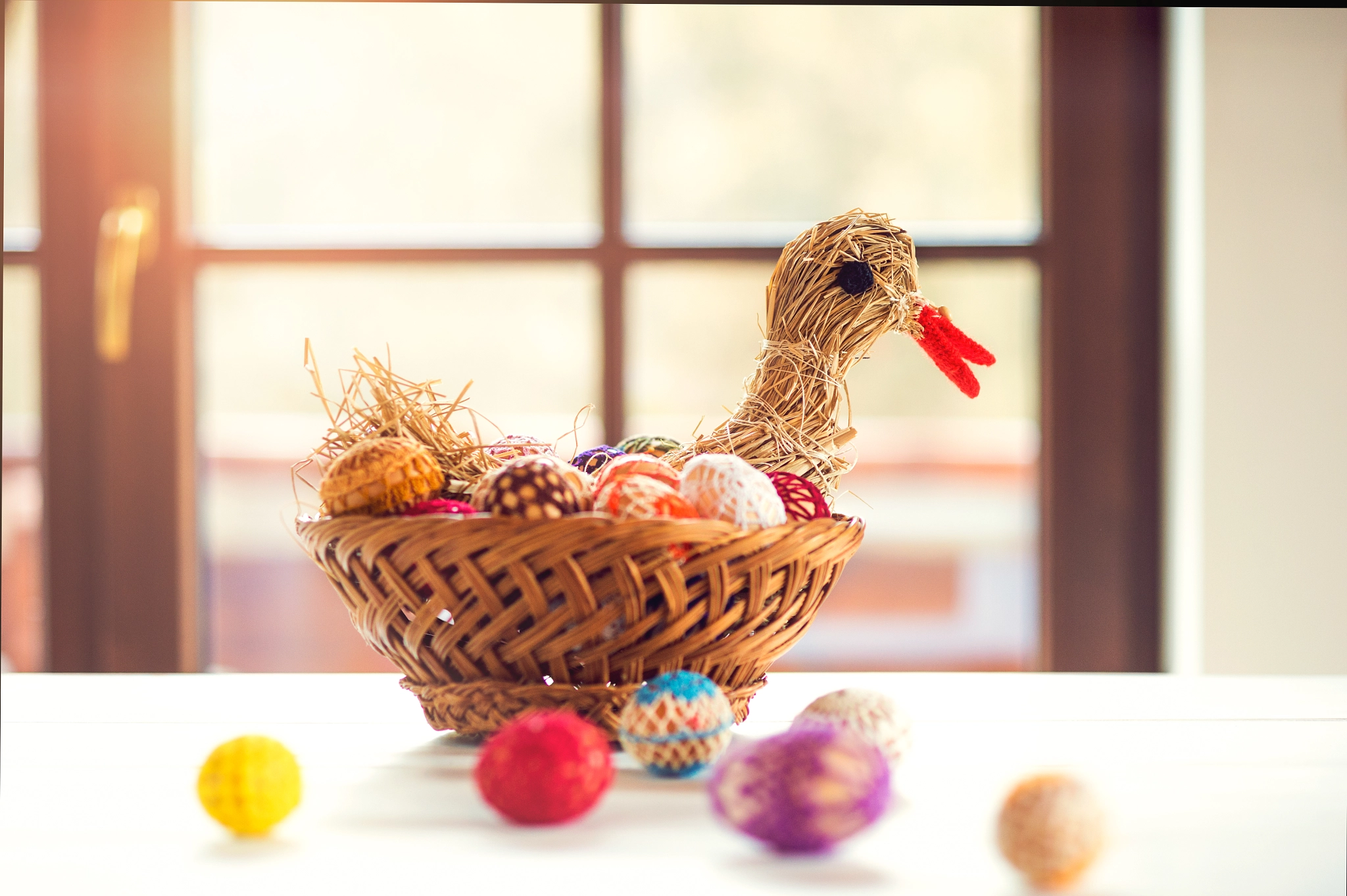 Nikon D4S + Nikon AF Nikkor 85mm F1.8D sample photo. Crocheted easter eggs and straw hen in wicker basket photography