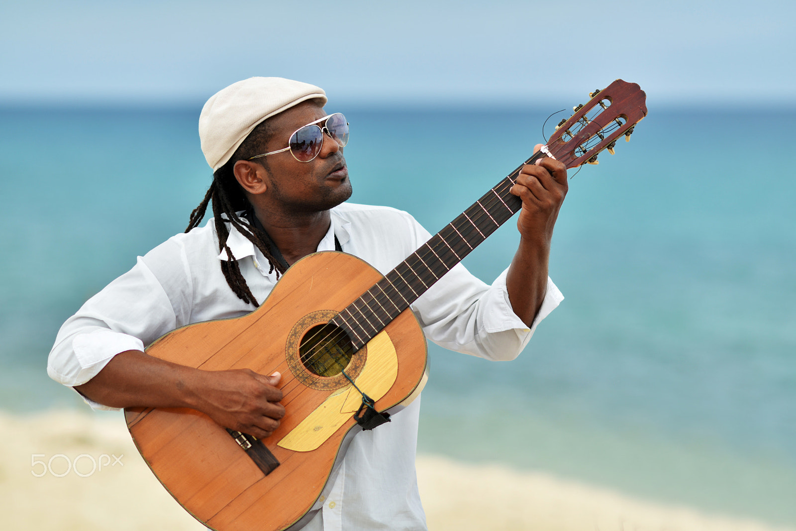 Nikon D810 + AF DC-Nikkor 135mm f/2D sample photo. Afro-american young handsome man in sunglasses and hat is playin photography