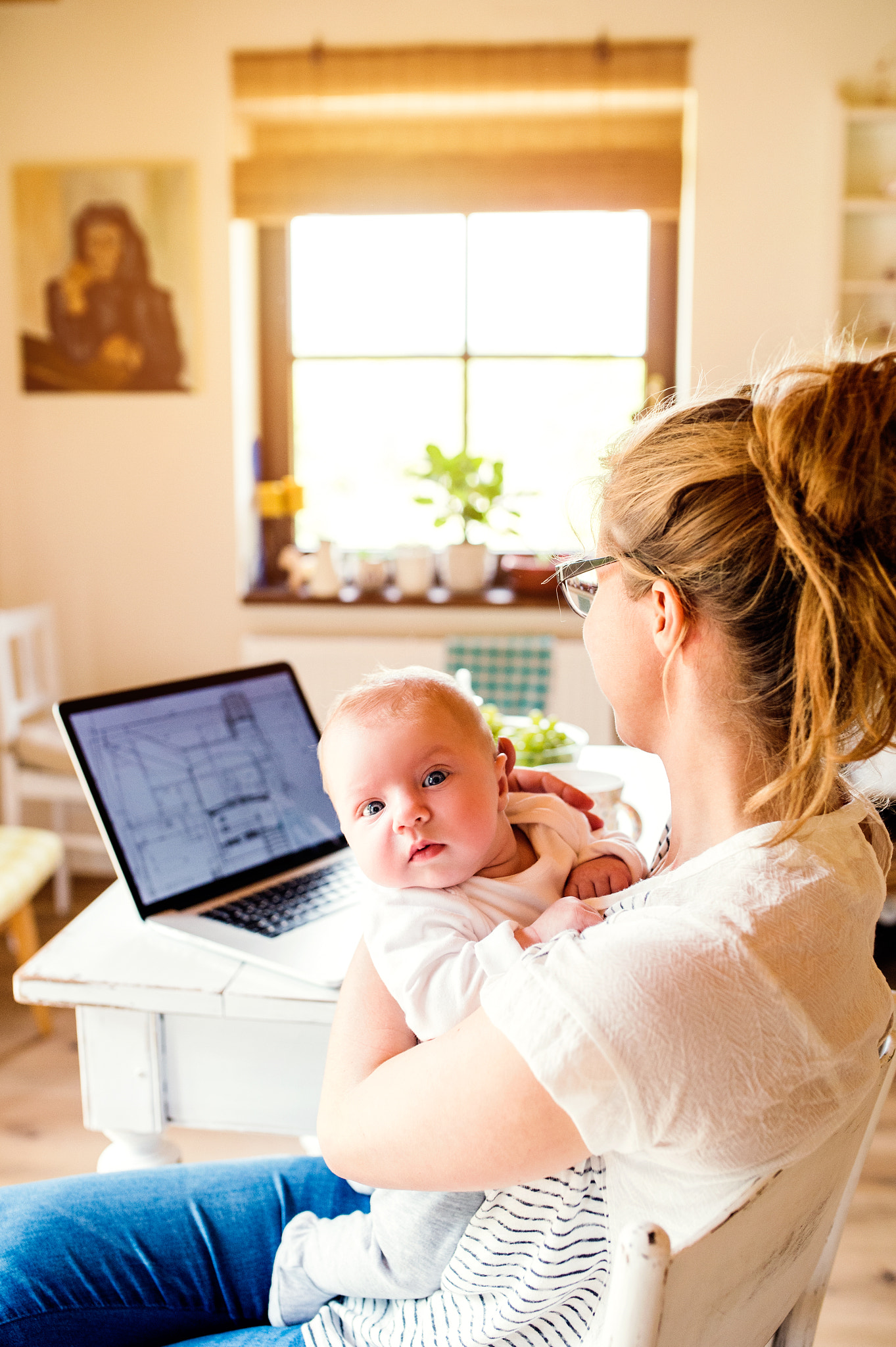 Nikon D4S sample photo. Beautiful mother holding baby son, laptop on table, close up photography
