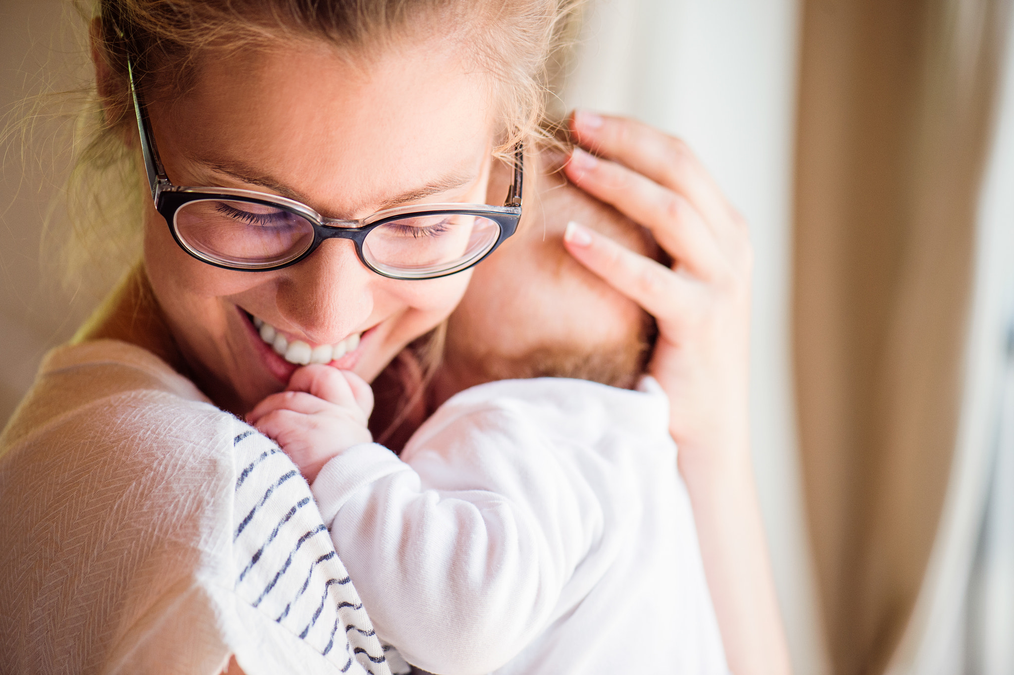 Close up of beautiful mother holding her baby son