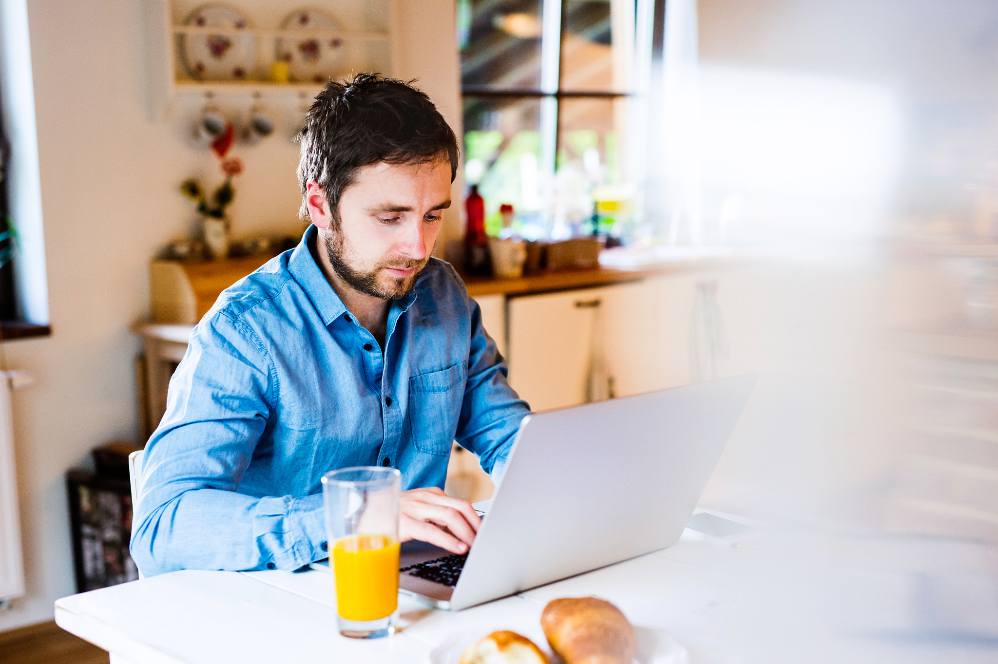 Nikon D4S + Sigma 50mm F1.4 DG HSM Art sample photo. Man sitting at desk working from home on laptop photography