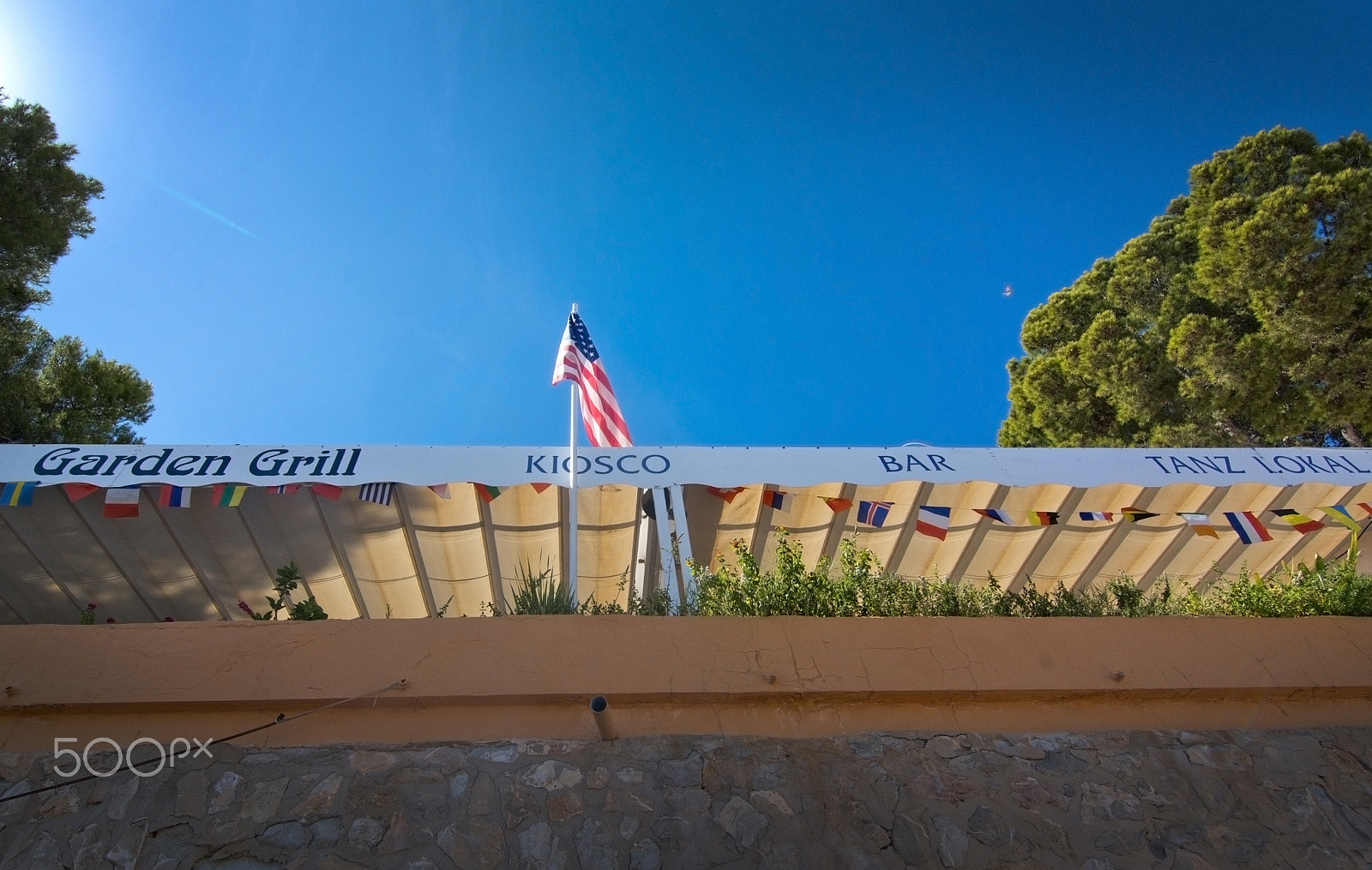 IX-Nikkor 60-180mm f/4.5-5.6 sample photo. Garden grill and bar with american flag photography