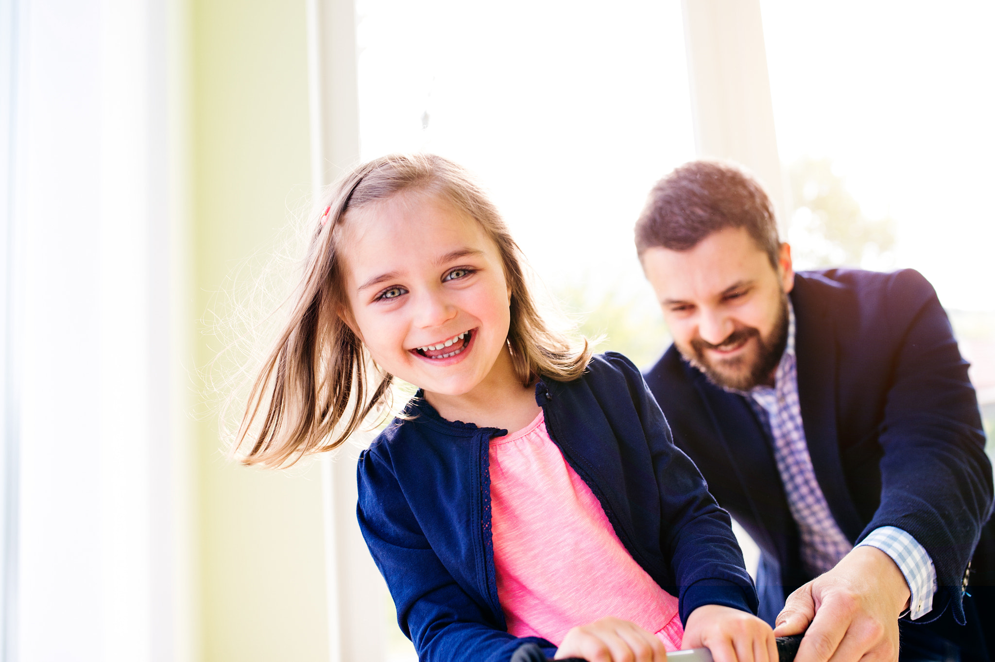 Nikon D4S + Sigma 35mm F1.4 DG HSM Art sample photo. Father and daughter playing together, riding a bike indoors photography