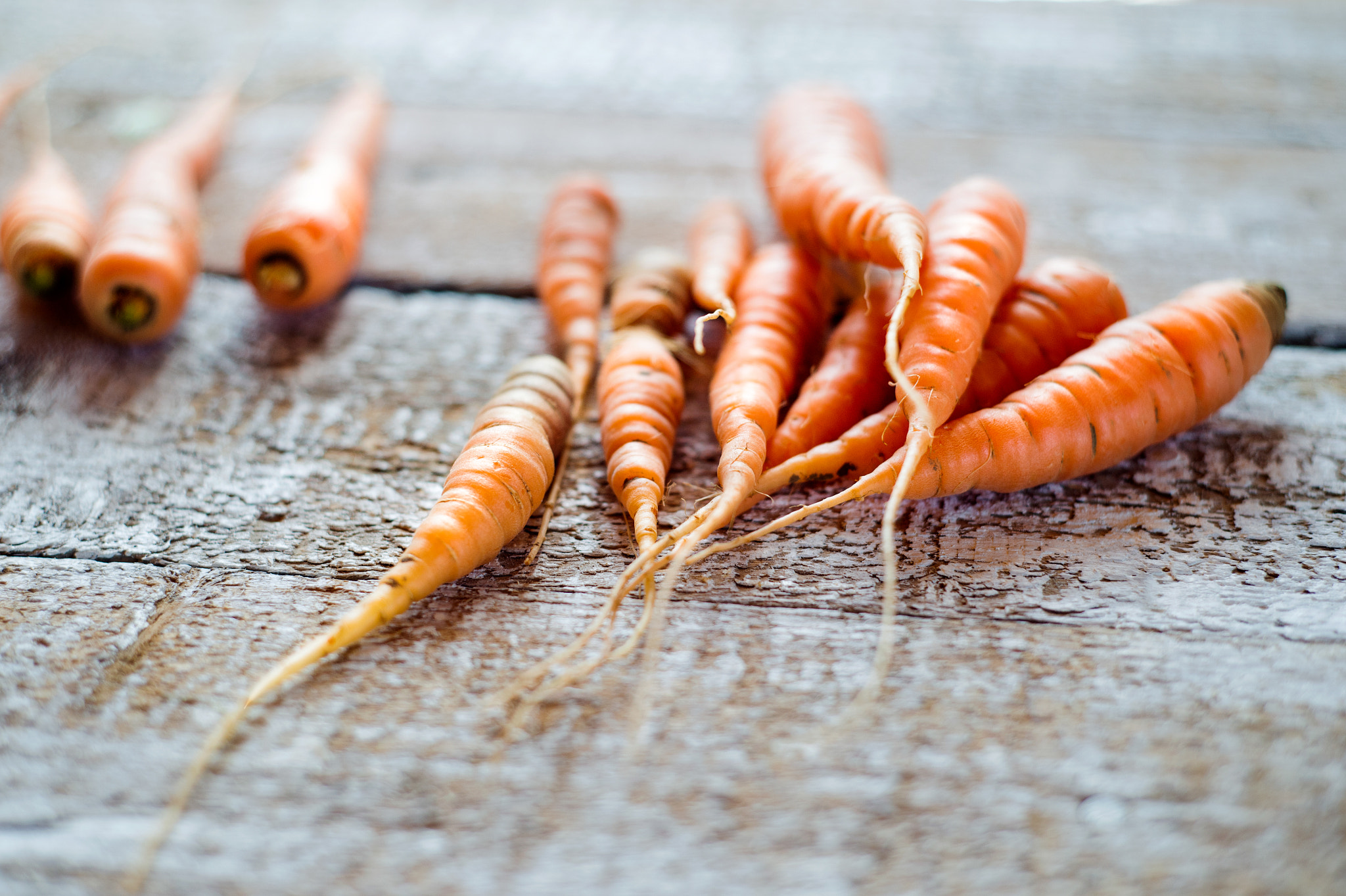 Nikon D4S + Nikon AF Nikkor 50mm F1.8D sample photo. Fresh carrot vegetable laid on white wooden table photography