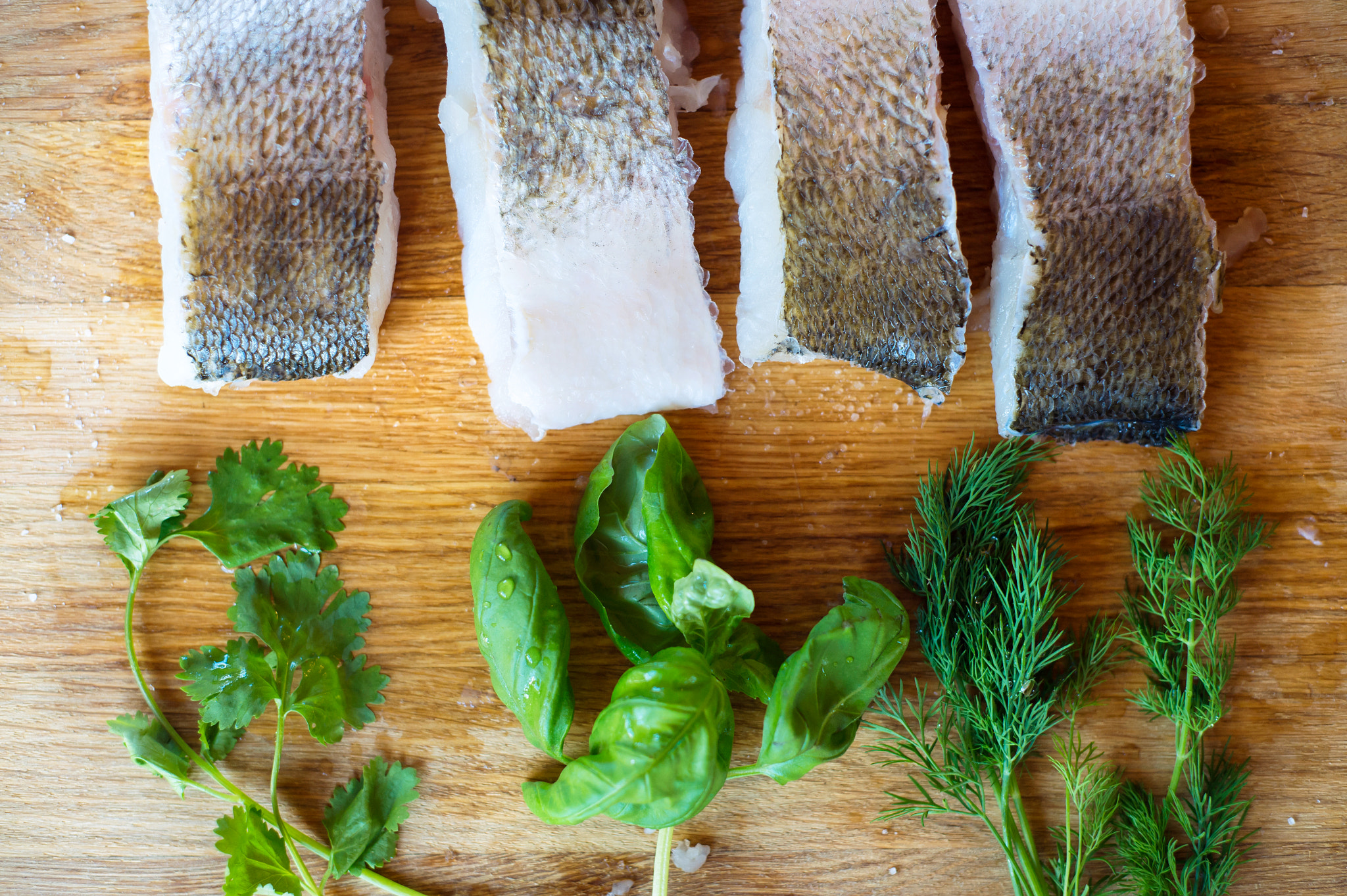Nikon D4S + Nikon AF Nikkor 50mm F1.8D sample photo. Raw zander fish fillets with various herbs, wooden background. photography