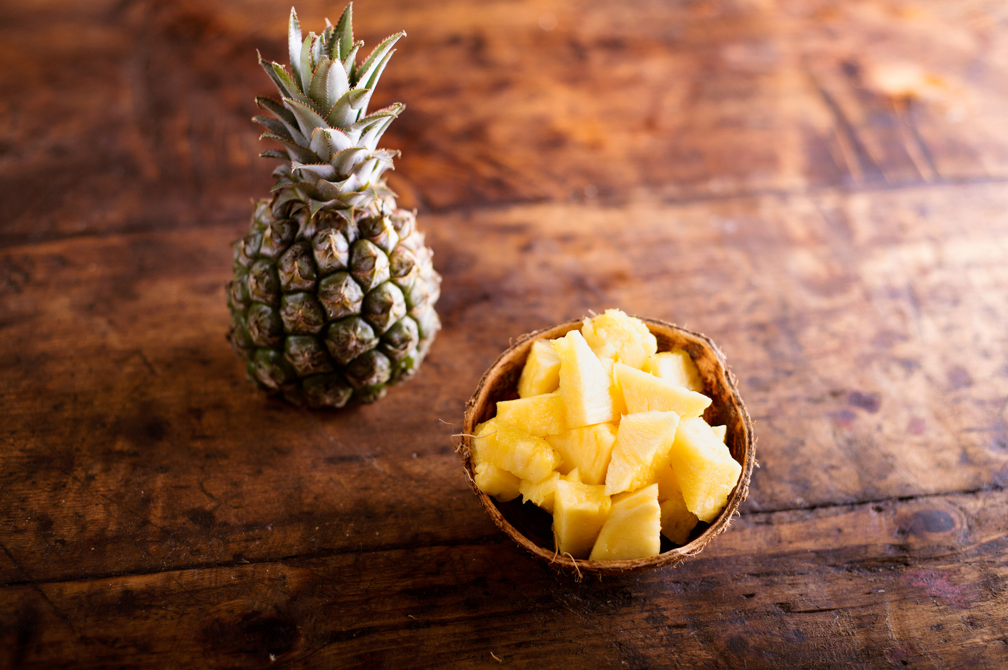 Nikon D4S + Nikon AF Nikkor 50mm F1.8D sample photo. Fresh ripe pineapple, whole and chopped in a bowl photography