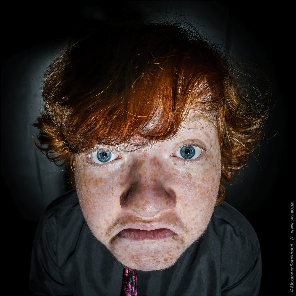 Sony FE 28mm F2 sample photo. Emotive portrait of red-haired freckled boy, childhood concept photography