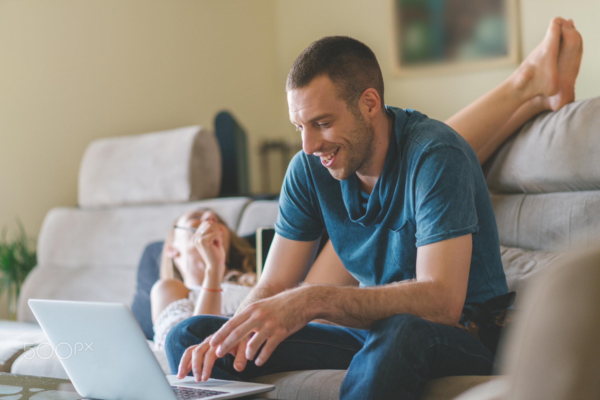 Young smiling couple working at home