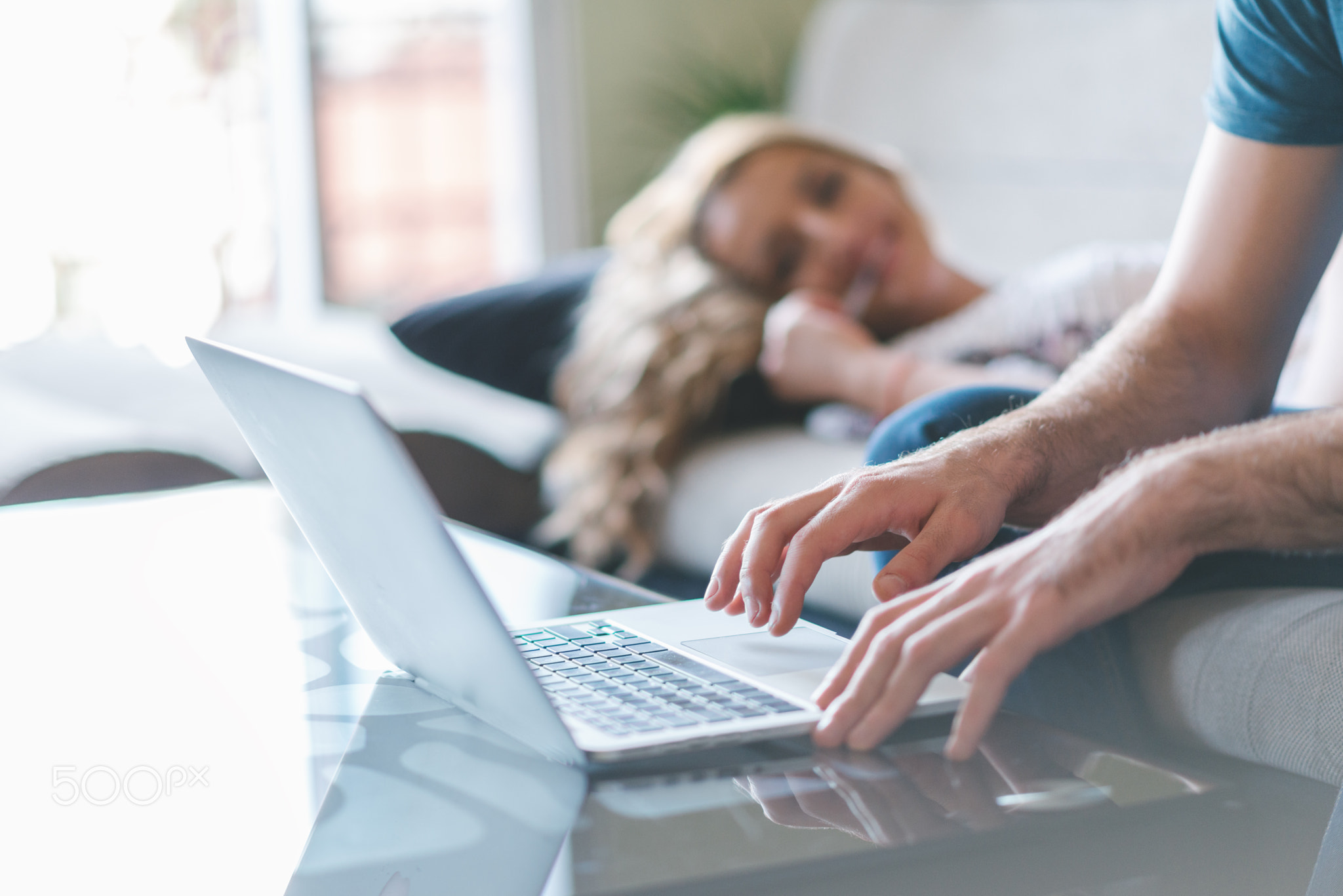 Young smiling couple working at home