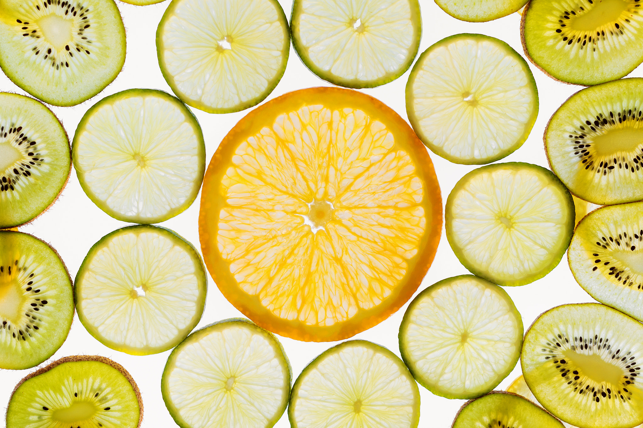 Nikon D4S sample photo. Fruit slices abstract pattern background, orange, limes and kiwi photography