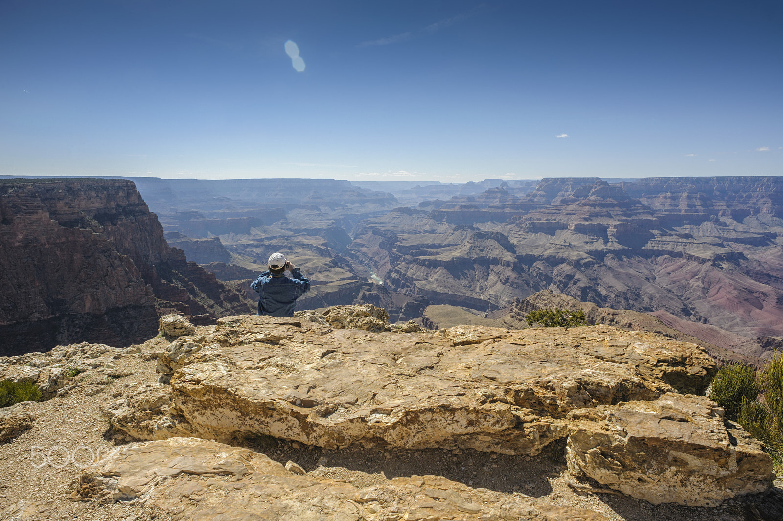 Nikon D700 + Nikon AF Nikkor 20mm F2.8D sample photo. Man takes photo at the edge of grand canyon photography