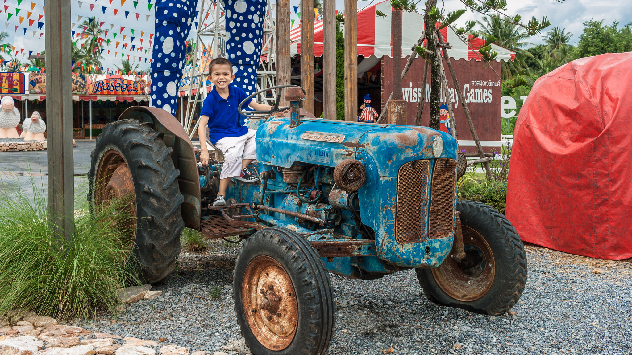 Canon EF-S 24mm F2.8 STM sample photo. Boy with tractor photography