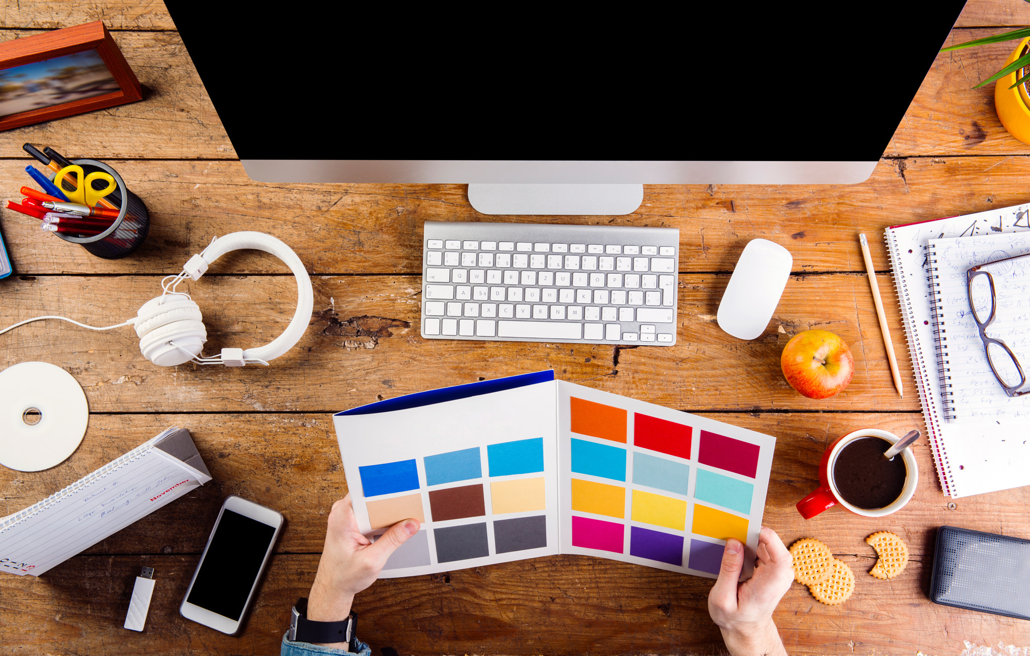 Designer at office desk working with color swatches