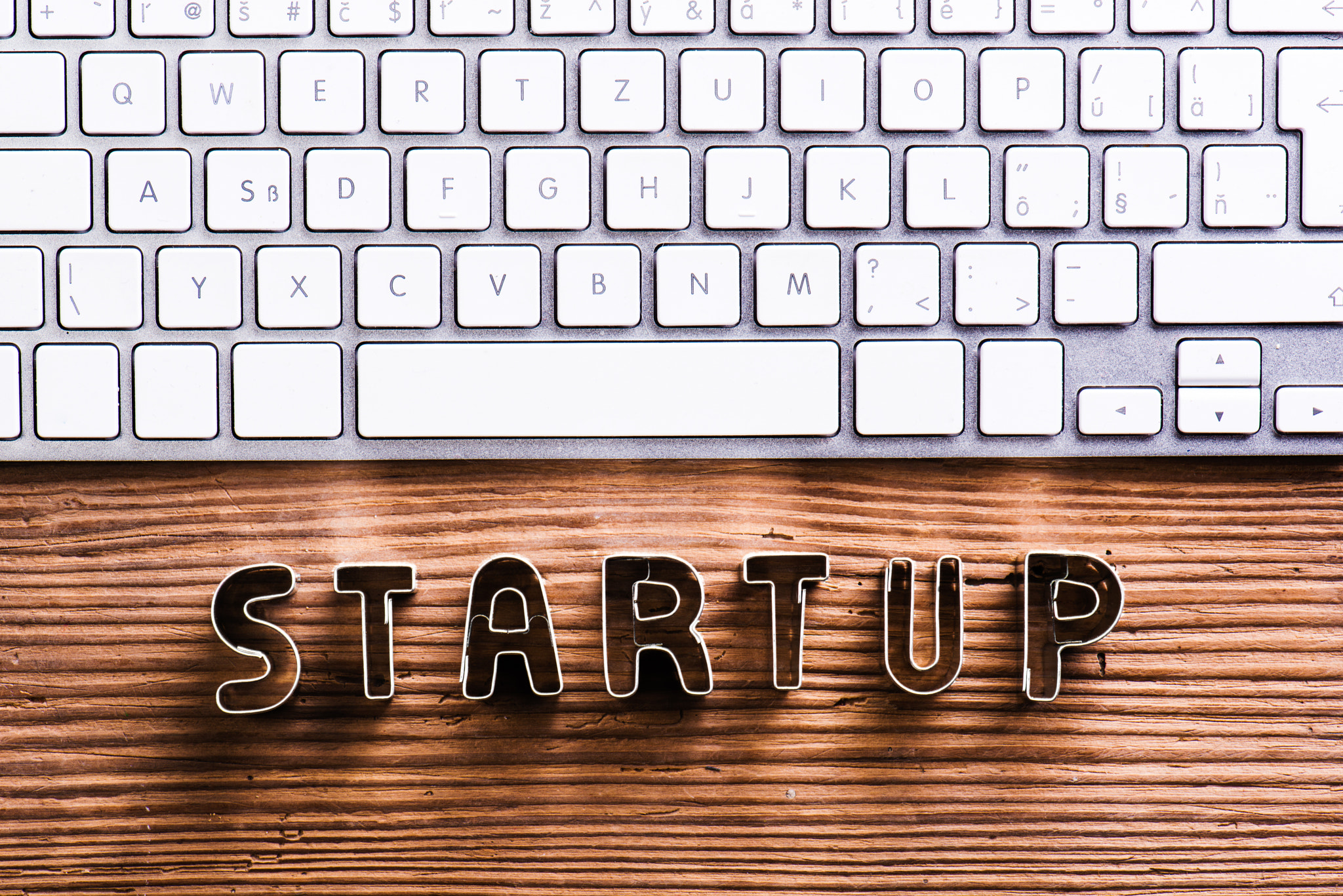 Office desk with start up sign and computer keyboard