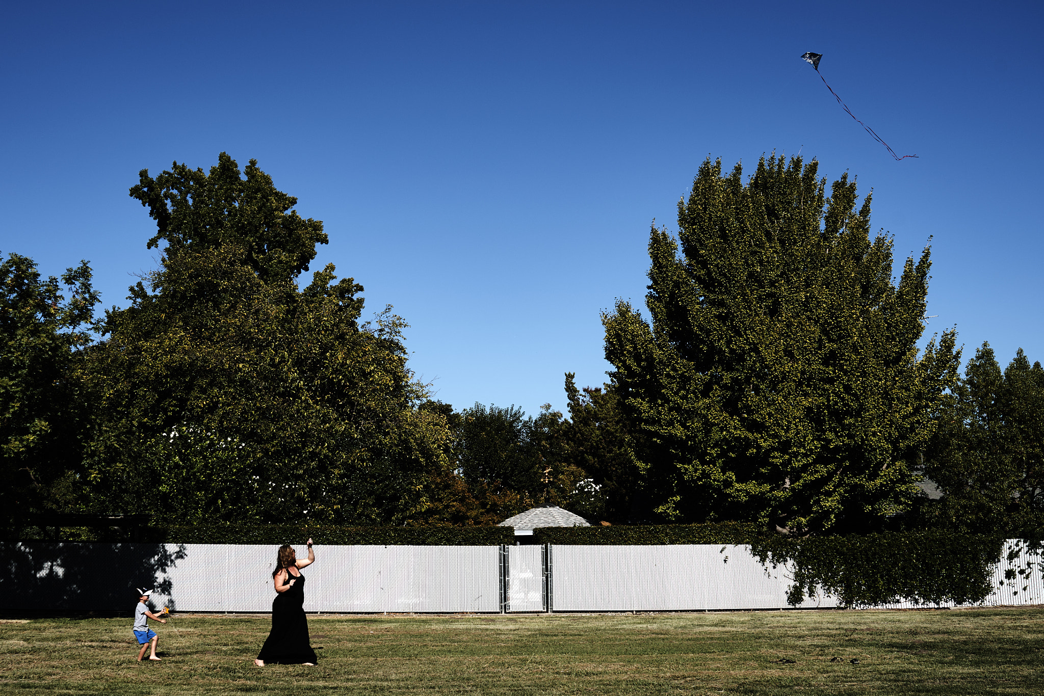 Sony a7 II sample photo. Son and mother connected on a kite string photography