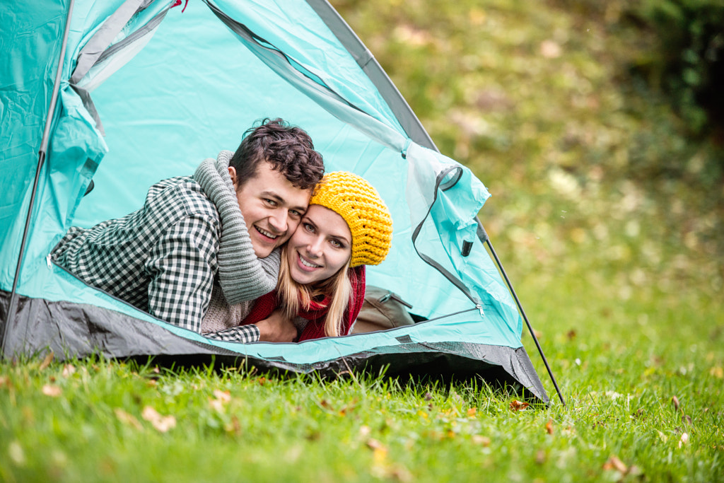 Couple poses - Beautiful couple lying in tent, camping in autumn nature by Jozef Polc on 500px.com