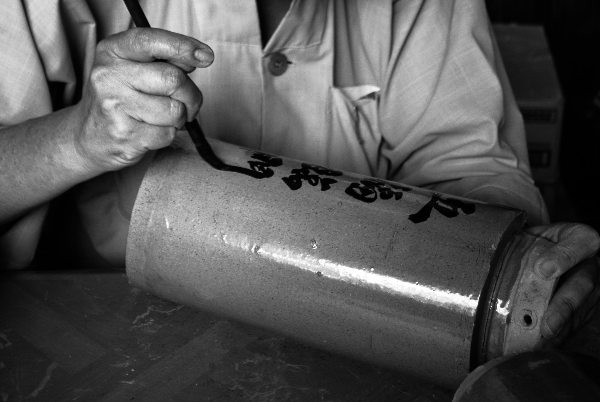 Sony Alpha DSLR-A200 sample photo. Kek lok si temple (a monk writing on slabs) photography
