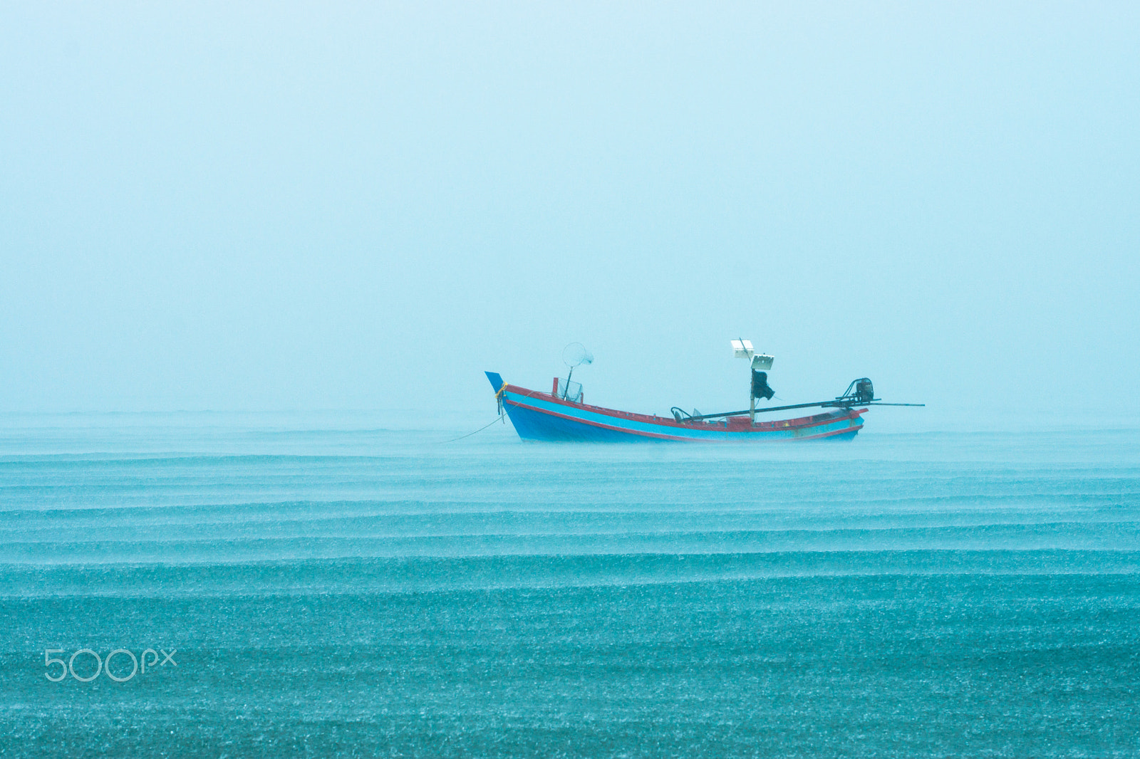 Sony DT 55-300mm F4.5-5.6 SAM sample photo. Fishing boat in the rainfall on the sea. photography