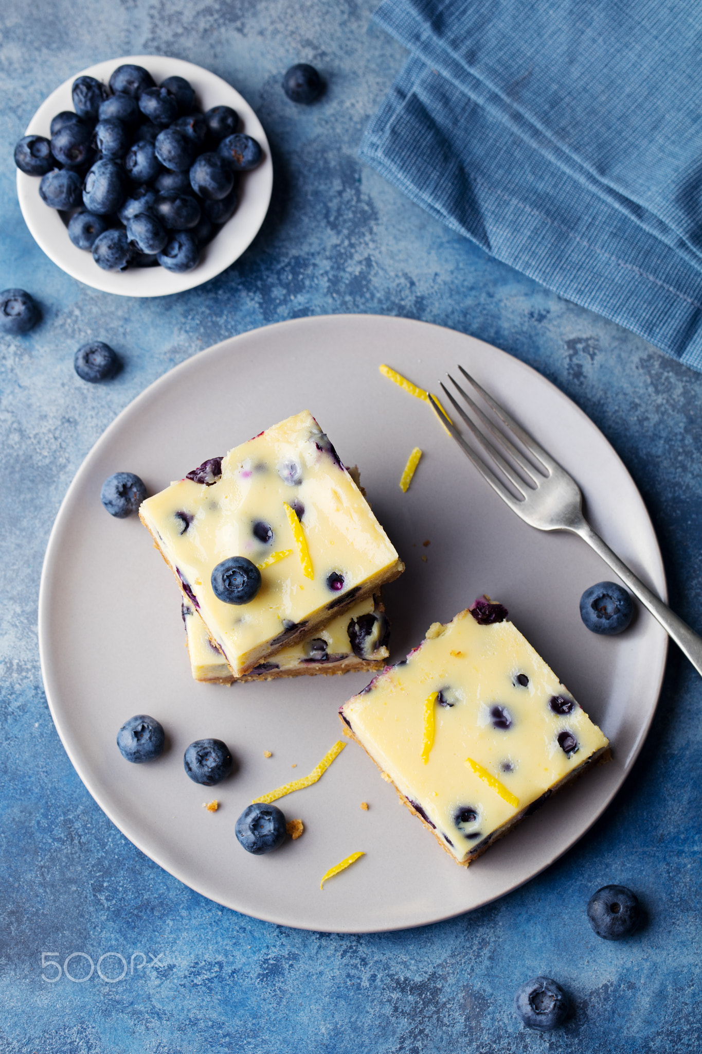 Blueberry bars, cake, cheesecake on a grey plate