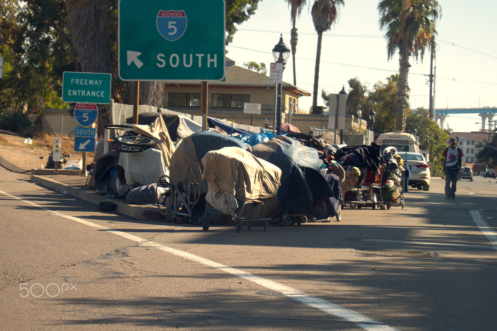 Canon EOS 500D (EOS Rebel T1i / EOS Kiss X3) sample photo. San diego homeless under the freeway sign photography