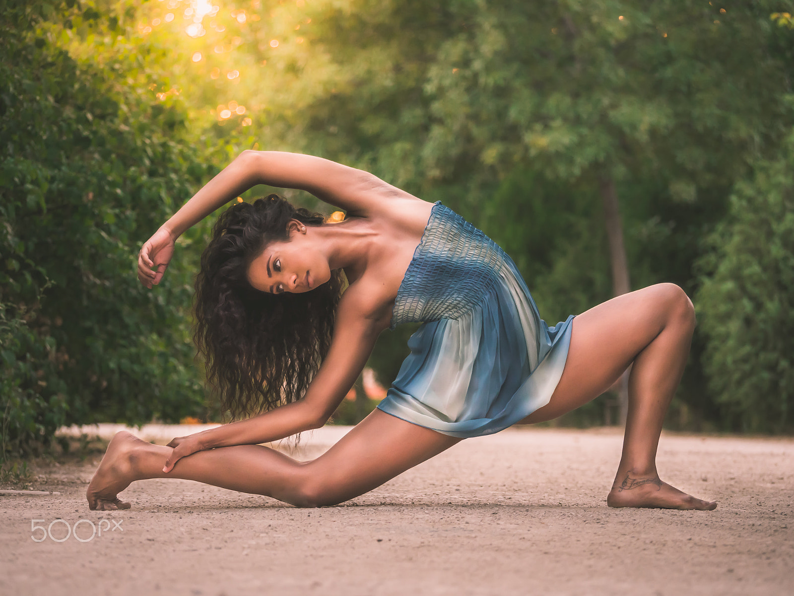Panasonic Lumix DMC-GH3 sample photo. Dancer stretching on the floor in a park photography