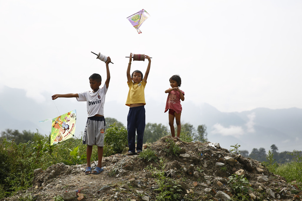Nepalese Boys fly Kites during Dashain Festival in Nepal by Skanda