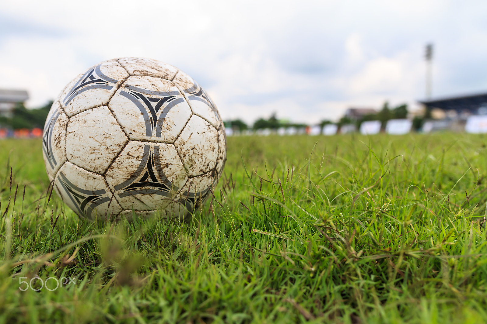 Sigma 18-35mm f/1.8 DC HSM sample photo. Muddy soccer ball on a football field photography