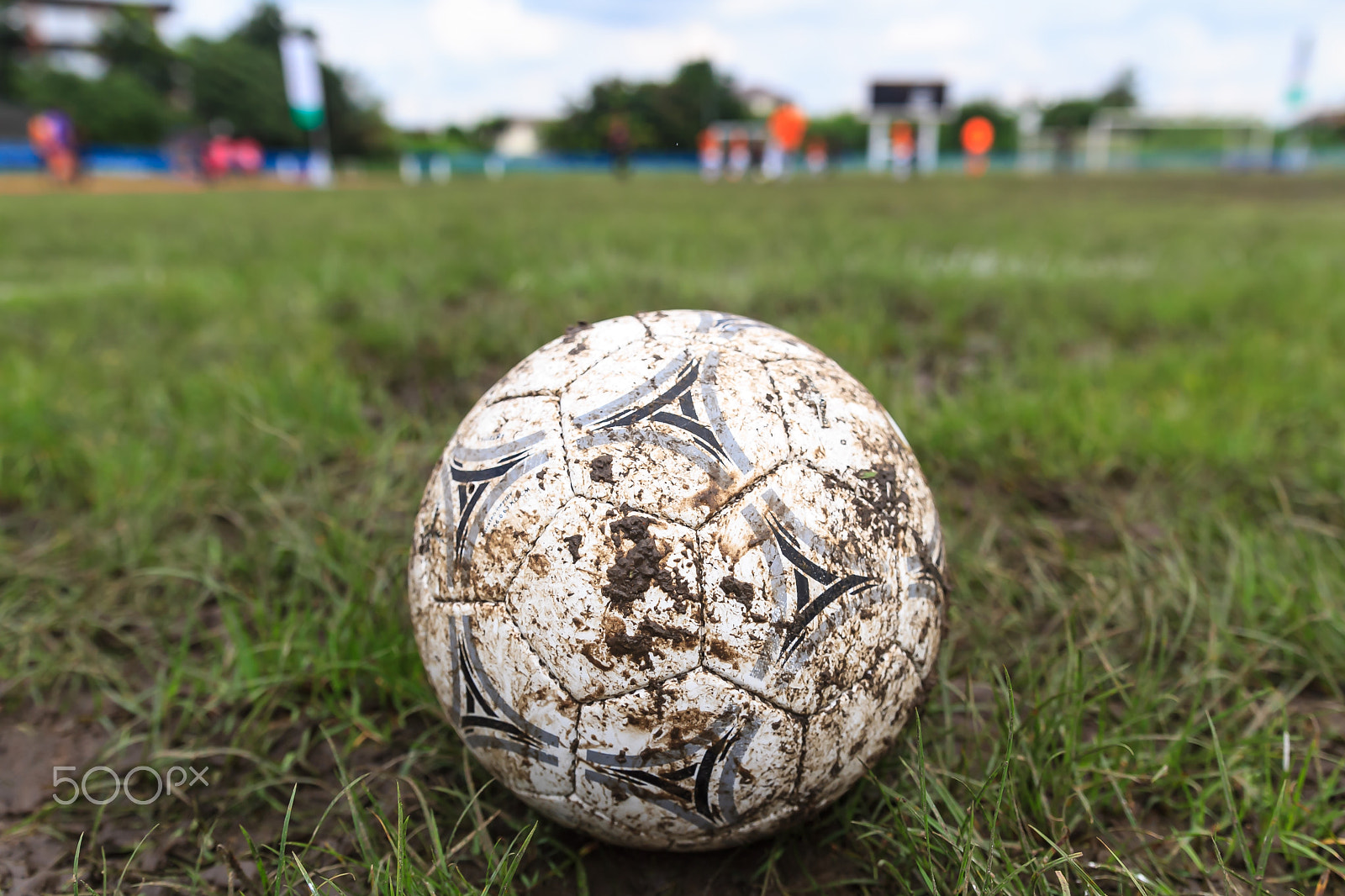 Sigma 18-35mm f/1.8 DC HSM sample photo. Muddy soccer ball on a football field photography