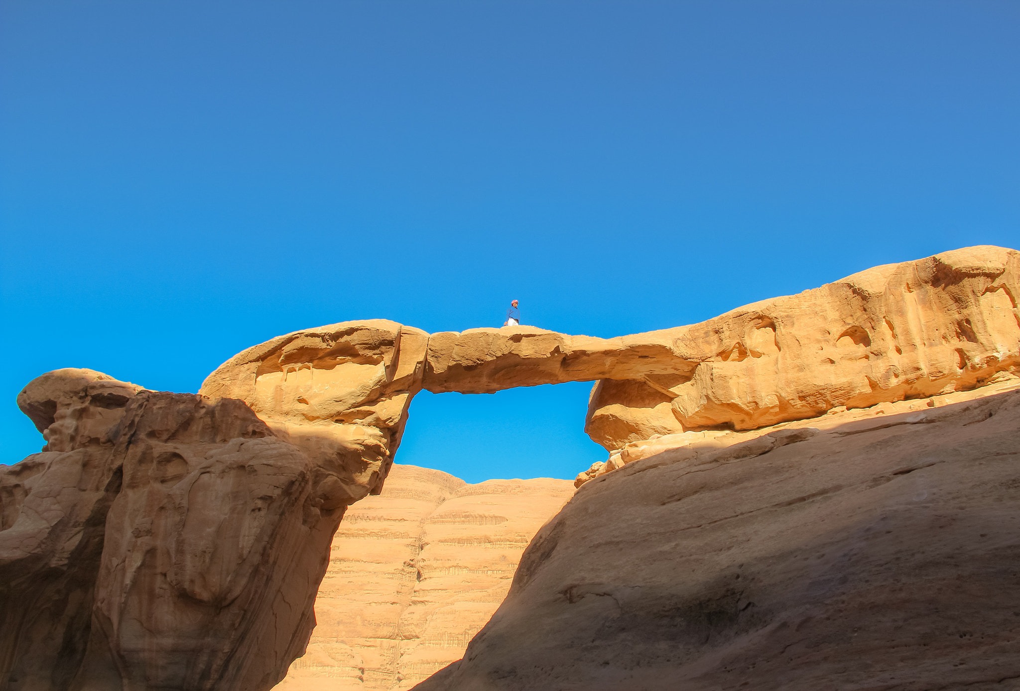 Canon EF-S 18-200mm F3.5-5.6 IS sample photo. Connected on natural rock bridge formation in wadi rum desert in jordan photography