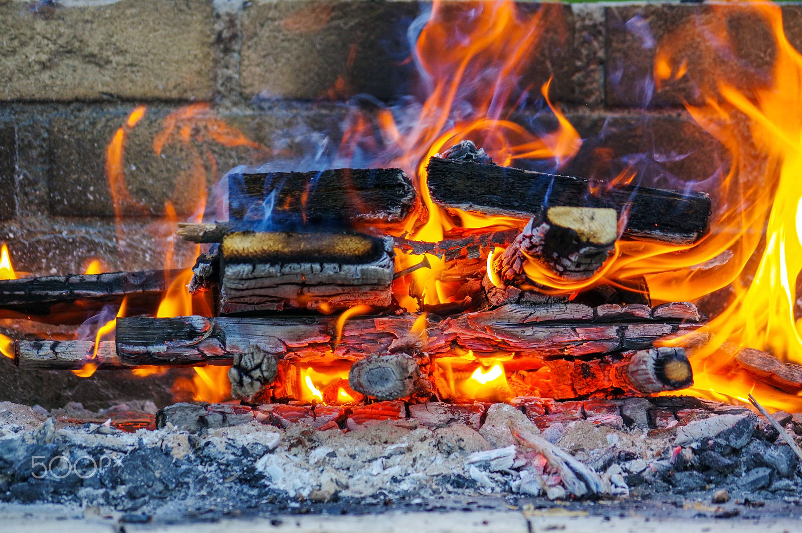 smc Pentax-DA L 50-200mm F4-5.6 ED WR sample photo. Flames on a barbecue grill with lot of charcoal photography