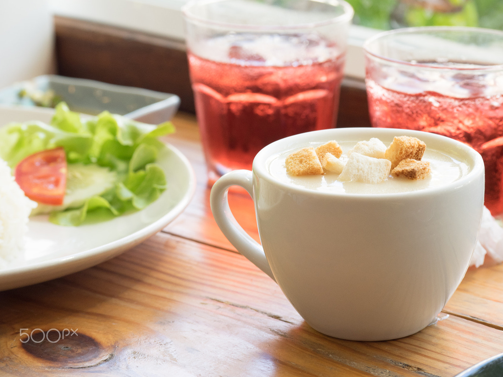 Panasonic Lumix G X Vario 35-100mm F2.8 OIS sample photo. Cream soup and bread toasted on wooden table photography
