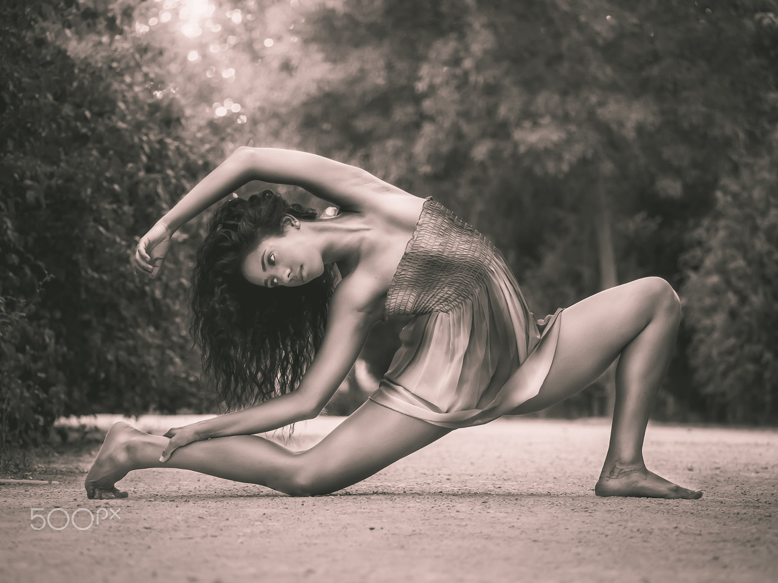 Panasonic Lumix DMC-GH3 sample photo. Monochrome dancer stretching on the floor in a park photography