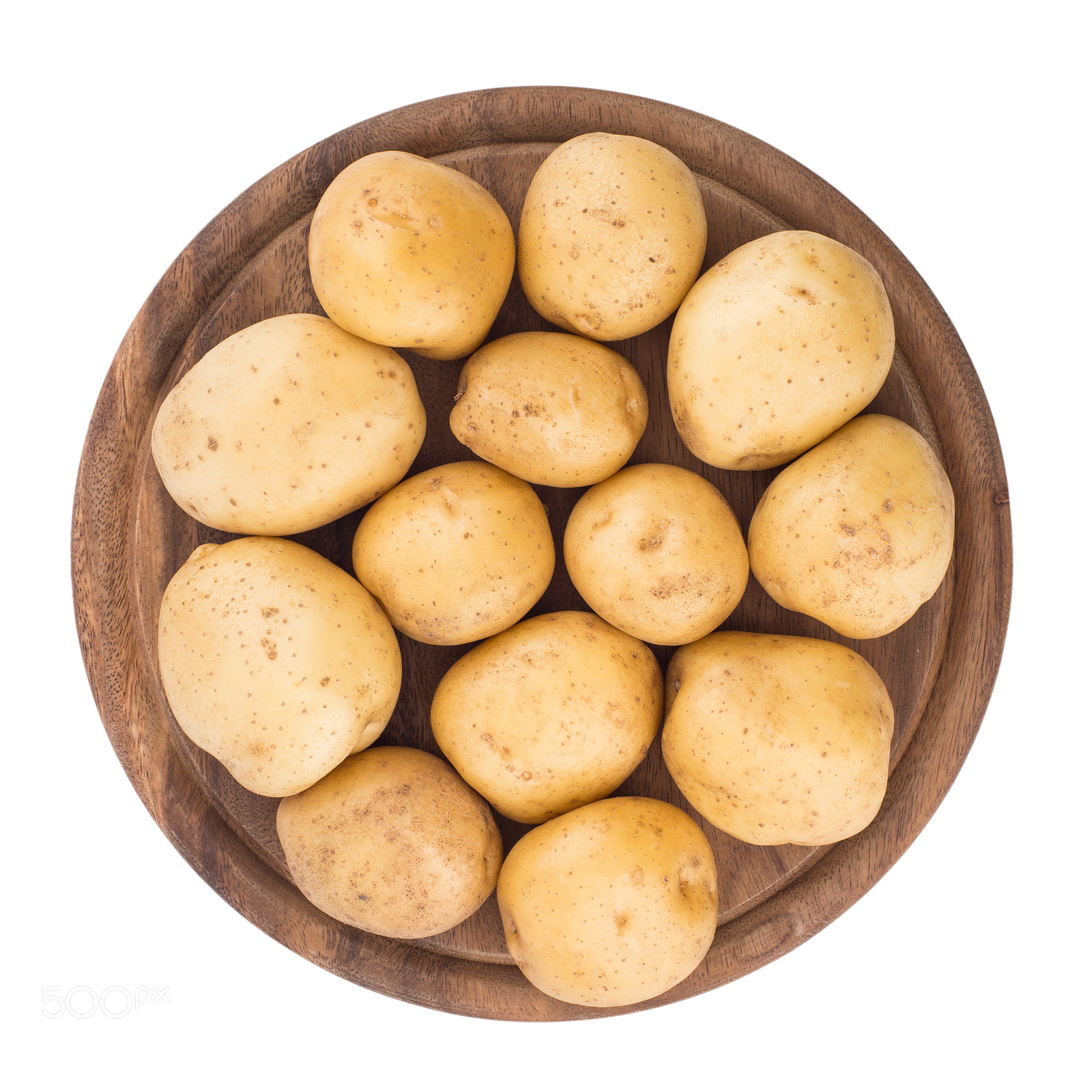 Sony a99 II sample photo. Young potatoes on a cutting board on white background close-up. photography