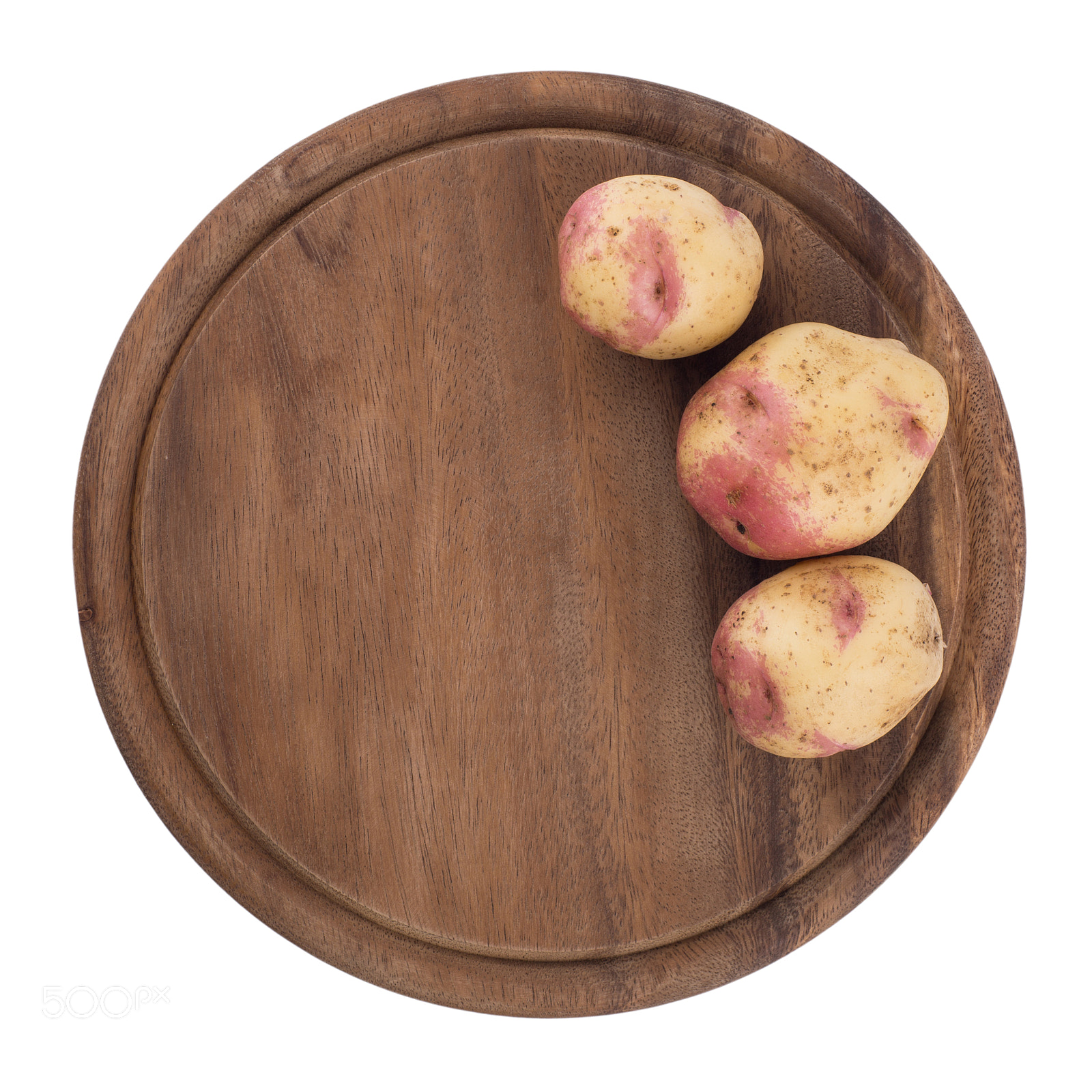 Sony a99 II sample photo. Young potatoes on a cutting board on white background close-up. photography