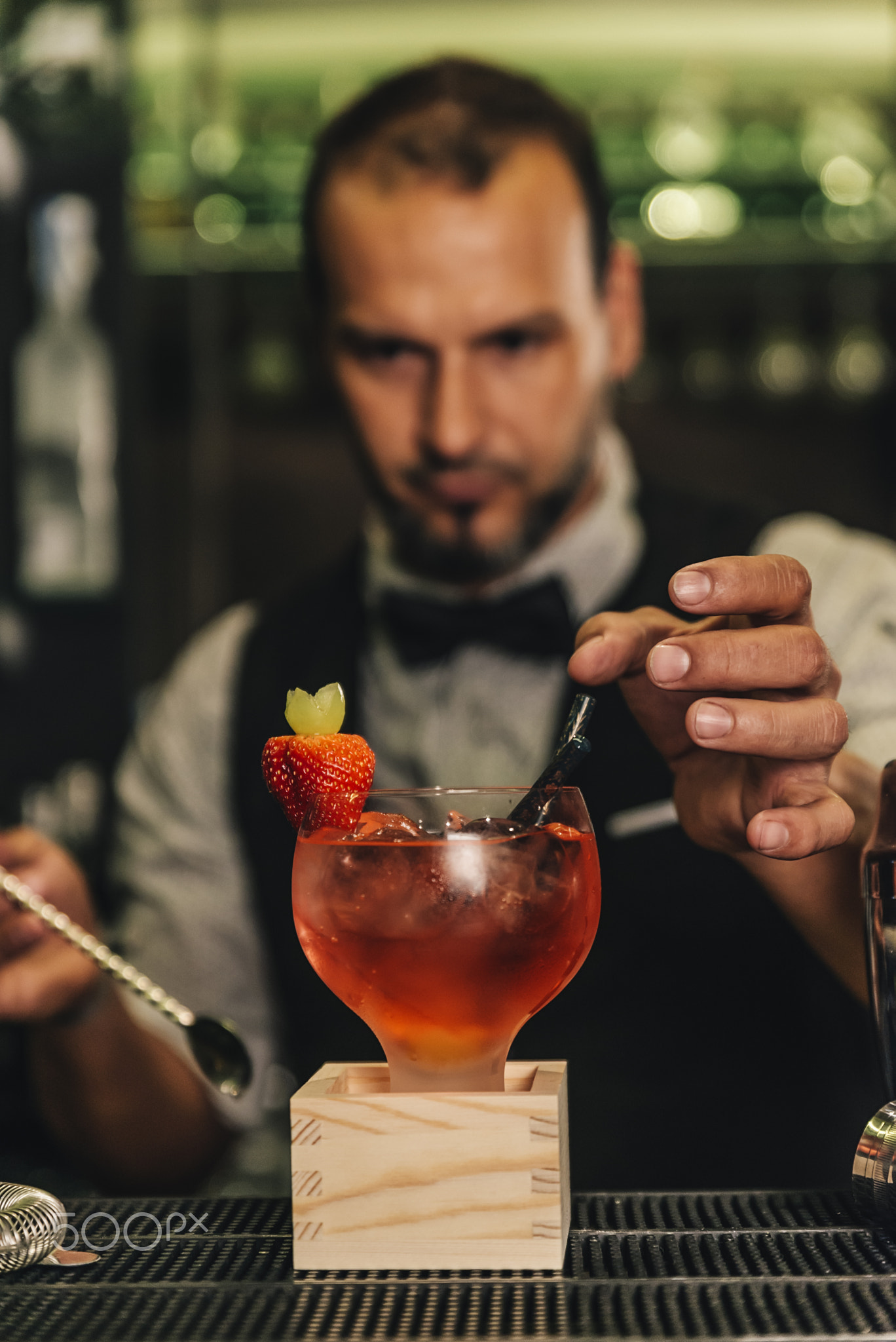 Barman is making cocktail at night club