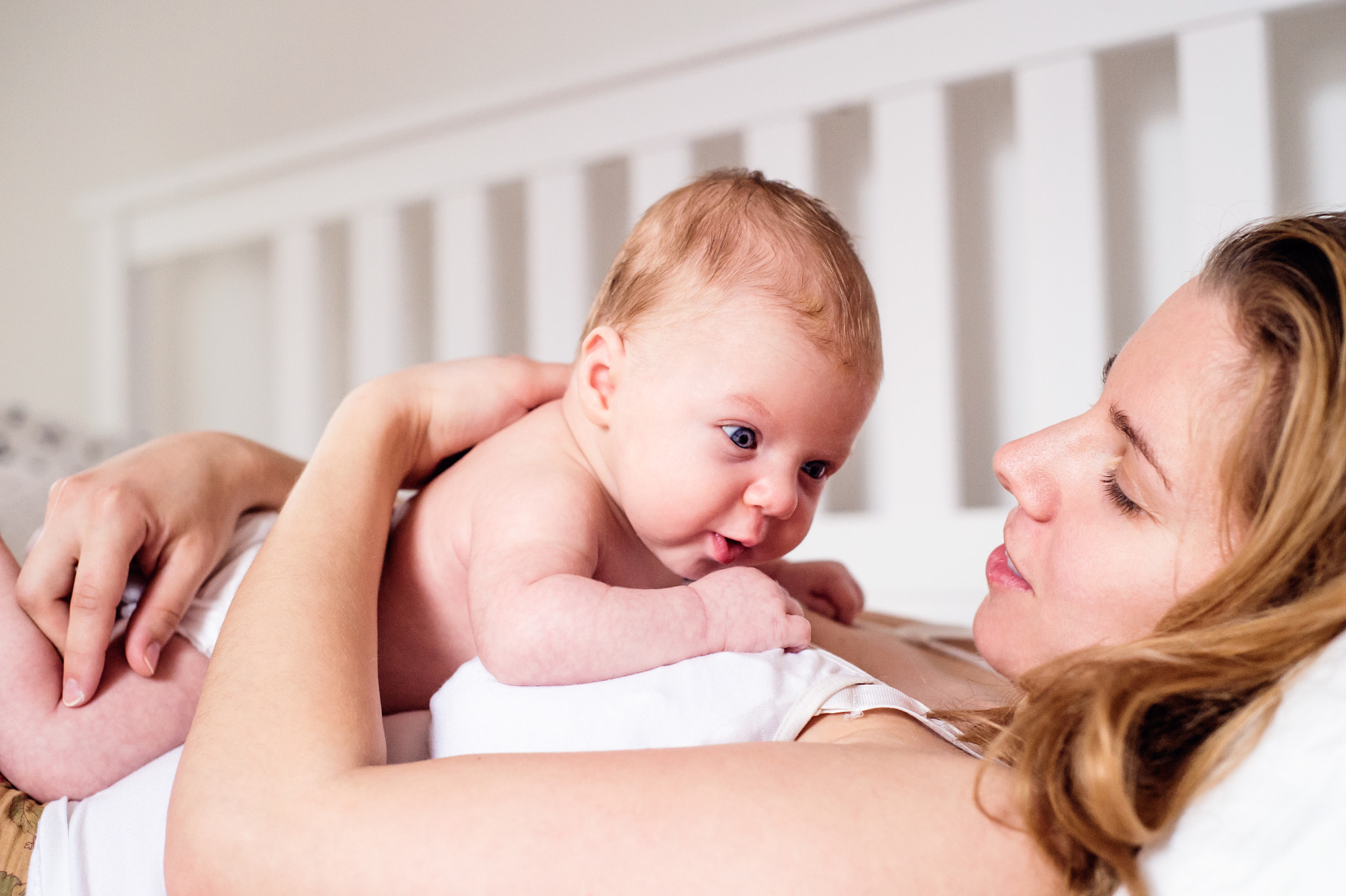 Nikon D4S + Nikon AF Nikkor 50mm F1.8D sample photo. Young mother holding her newborn baby son, home bedroom photography