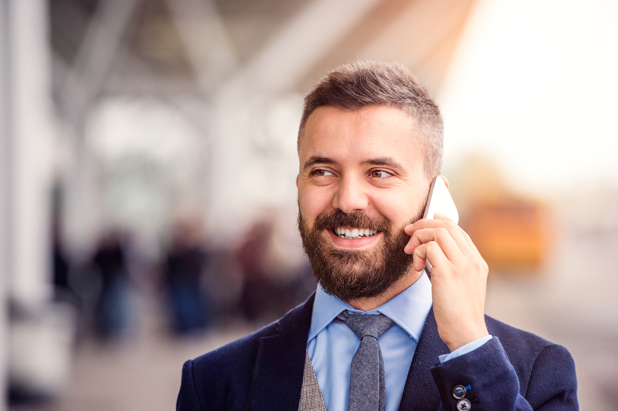 Hipster businessman making phone call waiting at the airport