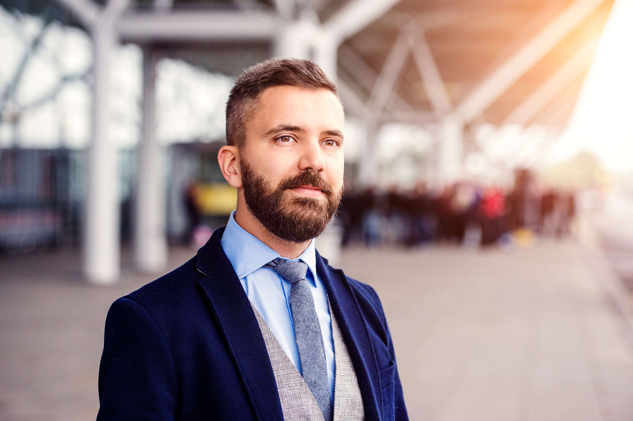 Hipster businessman in suit waiting at the airport