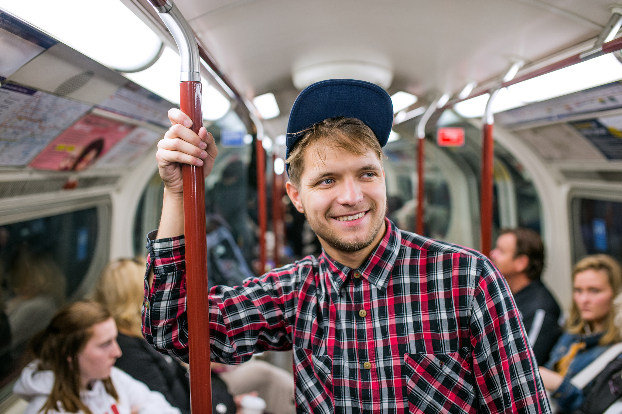 Nikon D4S + Sigma 35mm F1.4 DG HSM Art sample photo. Young hipster man standing in a crowded subway train photography