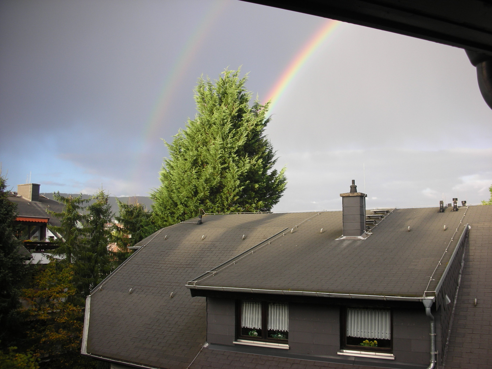 Nikon COOLPIX S6 sample photo. Two rainbows over tree and roof photography