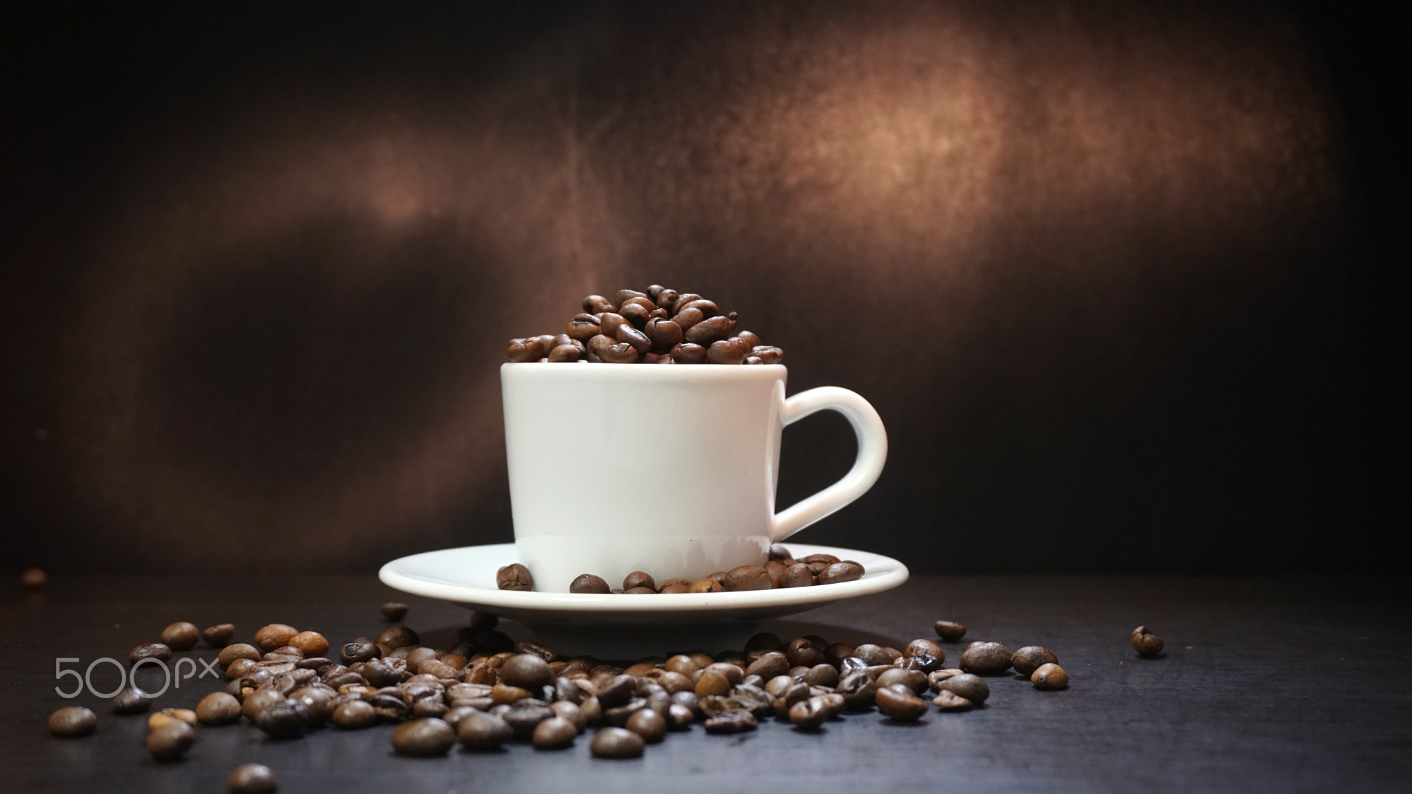 Cup With Coffee Beans Isolated on Black Background