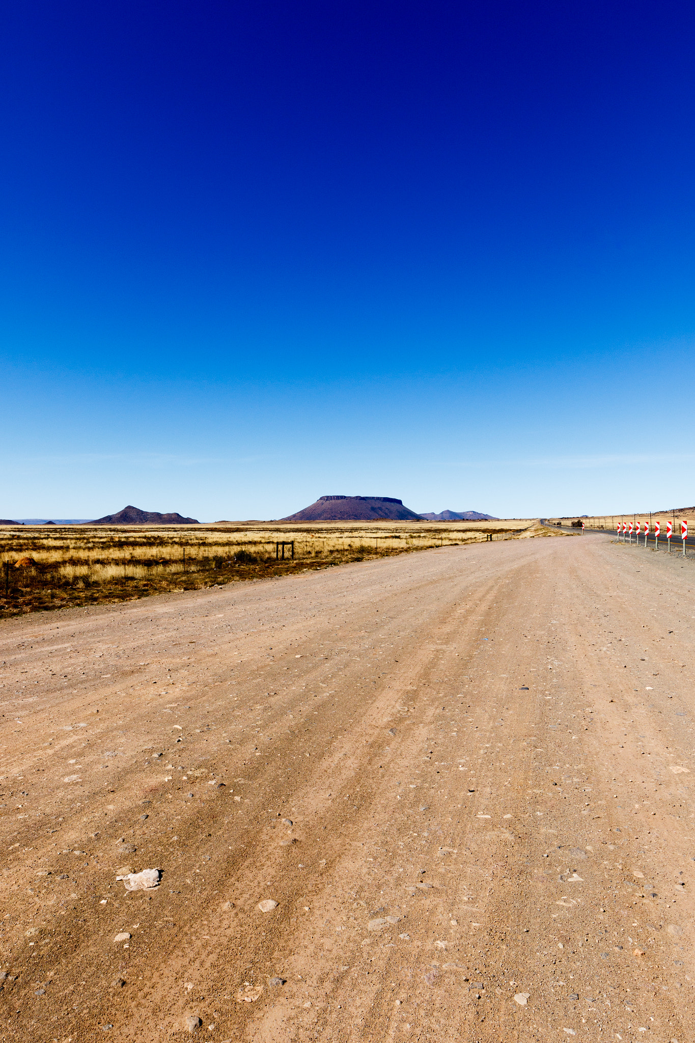 Canon EF 300mm f/2.8L sample photo. Dirt road with the view of the mountains on the side photography